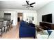 Open-concept living room features hardwood flooring, custom built-ins, a ceiling fan, and white cabinets at 2261 Osprey Ave, Orlando, FL 32814
