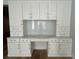 Charming office nook with white cabinets, marble countertops, and decorative backsplash at 2261 Osprey Ave, Orlando, FL 32814