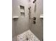 Modern tiled shower stall featuring pebble flooring and recessed shelving at 2261 Osprey Ave, Orlando, FL 32814