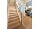 Elegant staircase featuring hardwood treads and white risers, leading to the upper level at 2261 Osprey Ave, Orlando, FL 32814