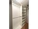 Bright walk-in closet featuring custom shelving, closet rods, and ample storage space for organization at 2261 Osprey Ave, Orlando, FL 32814