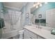 Bathroom with a tub/shower, a toilet, white cabinets and light blue paint at 2471 Yalaha Ave, The Villages, FL 32162
