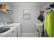 Bright laundry room with a utility sink and a newer model washing machine and dryer at 2471 Yalaha Ave, The Villages, FL 32162