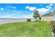 Well-maintained backyard with lush green grass and beautiful lake view at 251 Blue Cypress Dr, Groveland, FL 34736
