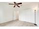 Light-filled bedroom featuring a ceiling fan, carpet flooring, and closet storage space at 251 Blue Cypress Dr, Groveland, FL 34736