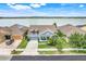 Charming single-Gathering home featuring a well-manicured front yard and scenic lake view at 251 Blue Cypress Dr, Groveland, FL 34736