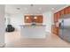 Modern kitchen with stainless steel appliances, granite countertops, and a breakfast bar overlooking the living area at 251 Blue Cypress Dr, Groveland, FL 34736