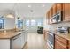 Updated kitchen featuring stainless steel appliances, stone countertops, and views of the lake and backyard seating area at 251 Blue Cypress Dr, Groveland, FL 34736