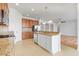 Open-concept kitchen with an island, stainless steel appliances, and views of the dining area and living room beyond at 251 Blue Cypress Dr, Groveland, FL 34736