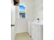 Bright laundry room featuring a full size washer and dryer, and wire shelving at 251 Blue Cypress Dr, Groveland, FL 34736