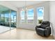Bright and airy living area with sliding glass doors and a large window offering peaceful lake views at 251 Blue Cypress Dr, Groveland, FL 34736