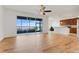 Bright living area with a ceiling fan, a view of the lake through sliding glass doors and sightlines into the kitchen at 251 Blue Cypress Dr, Groveland, FL 34736