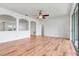 Open living room with wood flooring, neutral paint, and multiple archways for a modern feel at 251 Blue Cypress Dr, Groveland, FL 34736