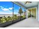 Spacious screened porch offering serene water views of the lake and lush backyard landscaping and covered seating area at 251 Blue Cypress Dr, Groveland, FL 34736