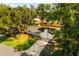 Aerial view of the house with driveway and mature trees at 2517 Royal Palm Dr, Edgewater, FL 32141