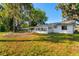 View of the backyard, patio, and mature trees at 2517 Royal Palm Dr, Edgewater, FL 32141