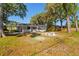 Large backyard features mature trees and outdoor seating area at 2517 Royal Palm Dr, Edgewater, FL 32141