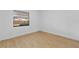 This empty bedroom is light and bright with laminate floors and a window at 2517 Royal Palm Dr, Edgewater, FL 32141