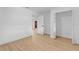A bright bedroom has laminate floors, white walls, baseboards, and multiple doors at 2517 Royal Palm Dr, Edgewater, FL 32141