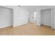 A bright bedroom has laminate floors, white walls, baseboards, and multiple doors at 2517 Royal Palm Dr, Edgewater, FL 32141