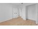 A bright bedroom has laminate floors, white walls, baseboards, and multiple doors at 2517 Royal Palm Dr, Edgewater, FL 32141