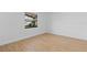 This empty bedroom is light and bright with laminate floors and a window at 2517 Royal Palm Dr, Edgewater, FL 32141