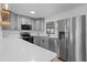 This kitchen features gray cabinets, stainless steel appliances, and a light countertop at 2517 Royal Palm Dr, Edgewater, FL 32141
