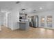 Modern kitchen featuring stainless steel appliances, gray cabinets, and a breakfast bar at 2517 Royal Palm Dr, Edgewater, FL 32141