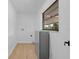 A well-lit laundry room has laminate floors and a window at 2517 Royal Palm Dr, Edgewater, FL 32141