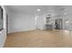 Open-concept living space featuring wood-look floors and a view of a modern kitchen with stainless appliances at 2517 Royal Palm Dr, Edgewater, FL 32141