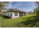 View of the house exterior, showing the screened lanai and expansive backyard at 25962 High Hampton Cir, Sorrento, FL 32776