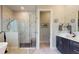 Bathroom showcases a glass-enclosed shower, a dark vanity with white countertops, and a toilet room at 25962 High Hampton Cir, Sorrento, FL 32776