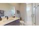 This bathroom has a walk-in shower with glass door, a gray vanity and a large mirror at 25962 High Hampton Cir, Sorrento, FL 32776