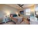 This bright bedroom features a ceiling fan, a large window, and coordinated decor at 25962 High Hampton Cir, Sorrento, FL 32776