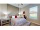 Bedroom with neutral walls features a ceiling fan, a window, and a bed with decorative pillows at 25962 High Hampton Cir, Sorrento, FL 32776