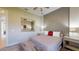 Bedroom features a bed with decorative pillows, a large mirror, and stylish side tables at 25962 High Hampton Cir, Sorrento, FL 32776