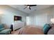 Bright bedroom with a ceiling fan, dresser, and a comfortable teal chair at 25962 High Hampton Cir, Sorrento, FL 32776