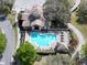 Aerial view of a community pool with red umbrellas at 25962 High Hampton Cir, Sorrento, FL 32776