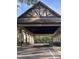 Grand entrance with a timber-framed roof creating an inviting arrival into the community at 25962 High Hampton Cir, Sorrento, FL 32776