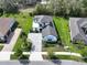 Aerial view of the beautifully landscaped home, with lush lawn and paver driveway at 25962 High Hampton Cir, Sorrento, FL 32776