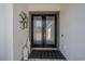 Elegant front entrance featuring double doors, modern decor, and a neutral color scheme, creating a welcoming ambiance at 25962 High Hampton Cir, Sorrento, FL 32776