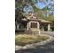 Charming gatehouse with stone accents, a tile roof, and well-maintained landscaping at 25962 High Hampton Cir, Sorrento, FL 32776