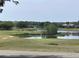 Scenic golf course view with lush greenery, water features, and well-maintained putting greens at 25962 High Hampton Cir, Sorrento, FL 32776