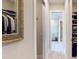Hallway with a walk-in closet and entry to the main bathroom with a shower at 25962 High Hampton Cir, Sorrento, FL 32776