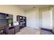 This home office has a gray desk, shelving, and a view of a closet and open door at 25962 High Hampton Cir, Sorrento, FL 32776