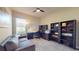 This home office with couch has a desk, shelving, and a window providing natural light at 25962 High Hampton Cir, Sorrento, FL 32776