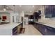 Spacious kitchen with modern dark cabinetry, quartz countertops, stainless steel appliances, and a large island at 25962 High Hampton Cir, Sorrento, FL 32776