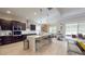 Spacious kitchen with dark wood cabinetry, quartz countertops, and an island with bar seating and stainless appliances at 25962 High Hampton Cir, Sorrento, FL 32776