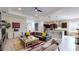 Open-concept living space that includes a modern sectional, stylish decor, and seamless transition to the kitchen at 25962 High Hampton Cir, Sorrento, FL 32776