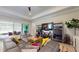 Bright living room featuring modern furniture, a large sectional sofa, and stylish decor with large sliding glass doors at 25962 High Hampton Cir, Sorrento, FL 32776